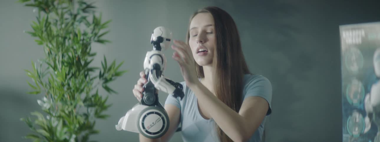 Female robotic engineer inspecting a hand held robot