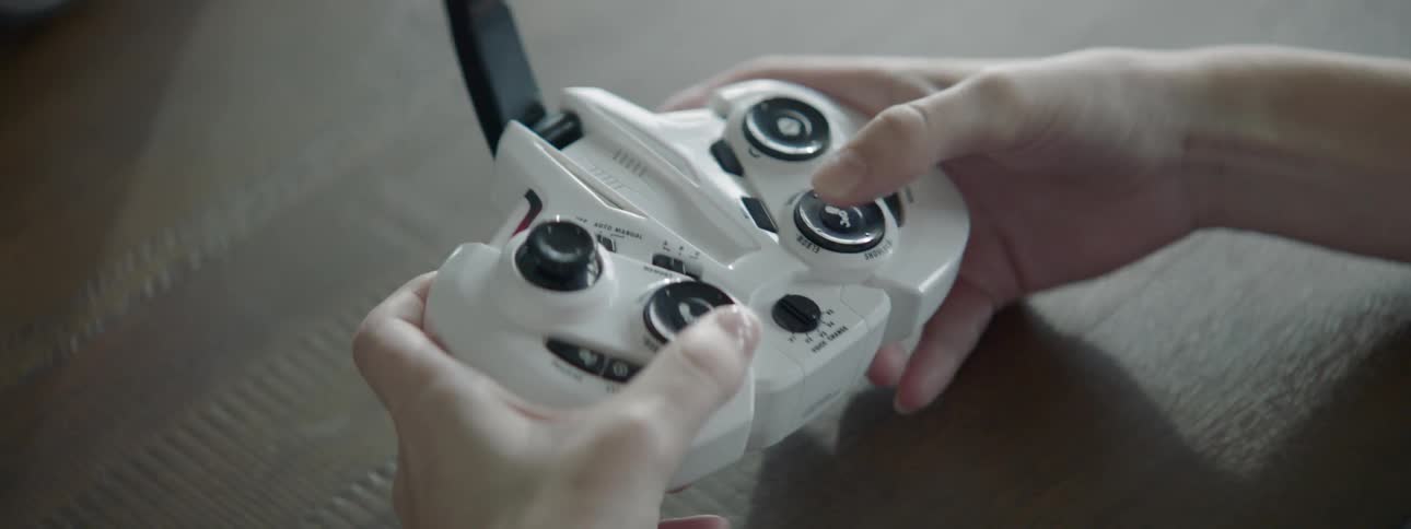 A person is using a white controller to play videogames