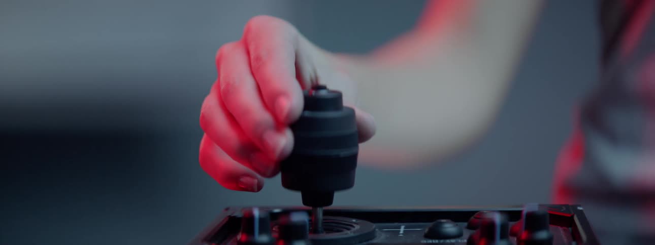 A woman adjusting knobs on a control device