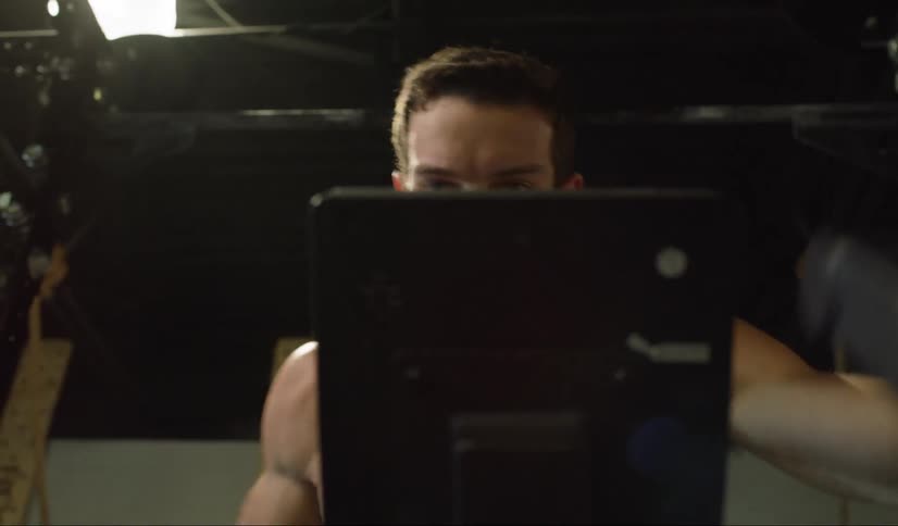A man exercises on an indoor bicycle