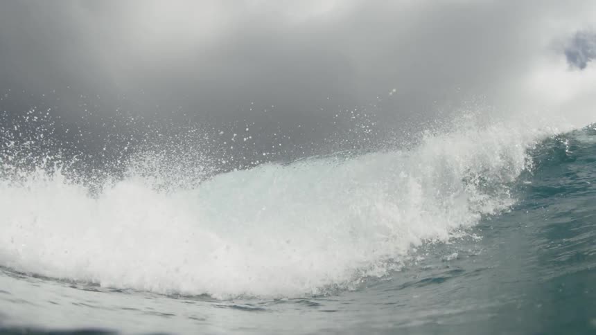 Wave crashing above the surface in the ocean