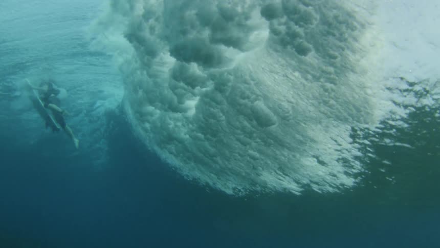 Underwater footage of surfer being dragged by a wave