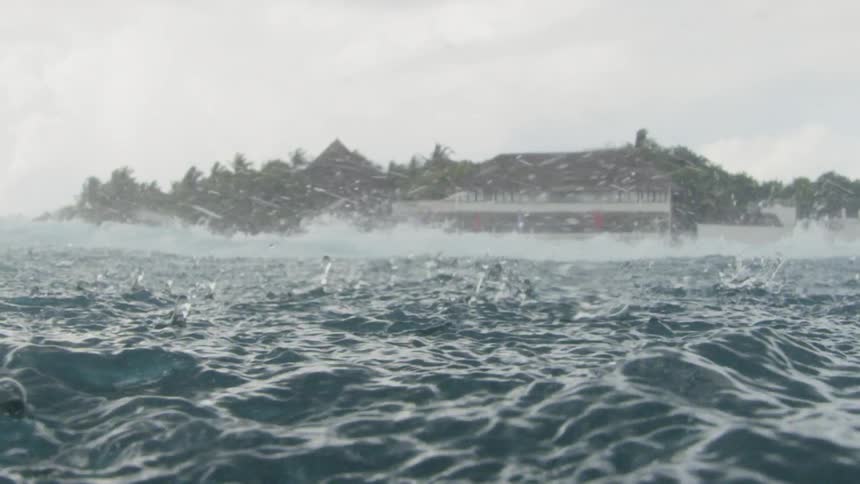 Waves crashing as rain falls