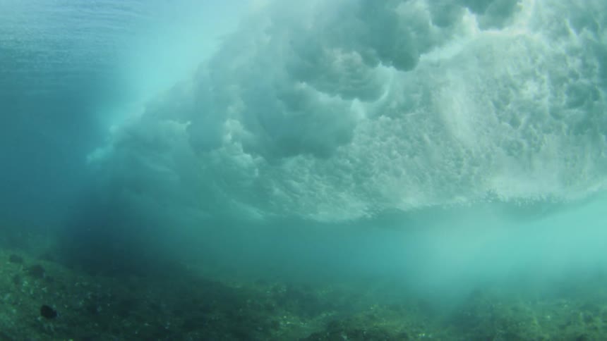 Waves crashing as seen from underwater with the fish