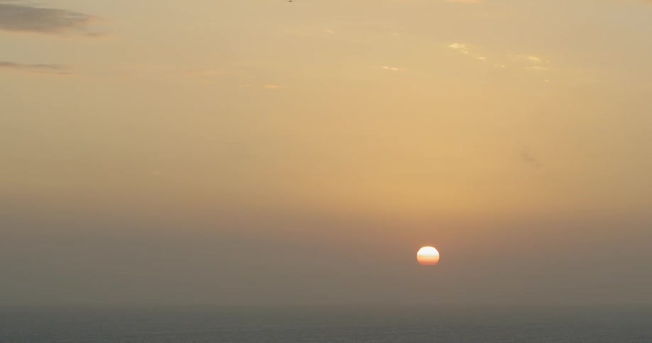 The sun setting over the ocean