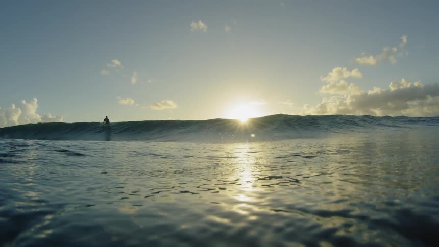 A large wave lifts in the ocean waters