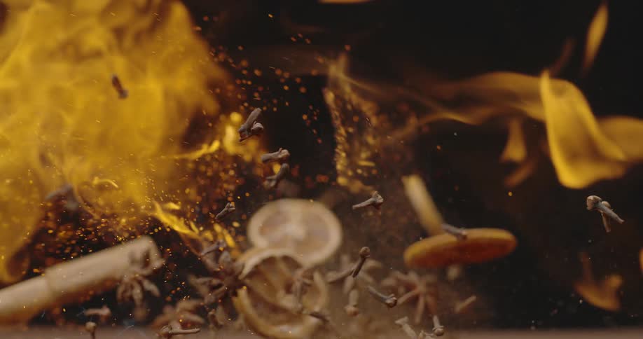 Lemon slices and debris bounce as flames cross over them
