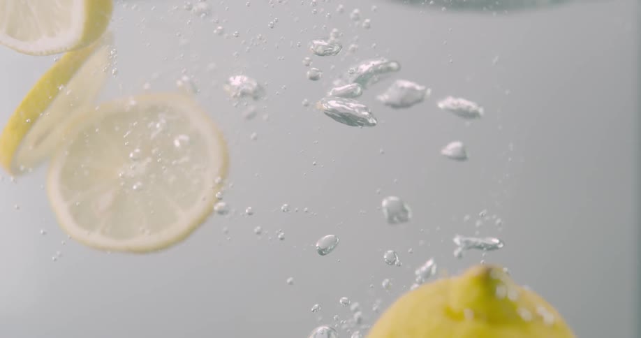 Orange slices falling down the water