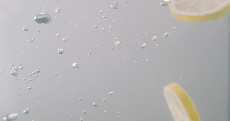 Lemon slices drop into water