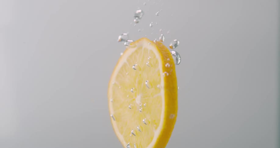 A lemon slice dropping into water
