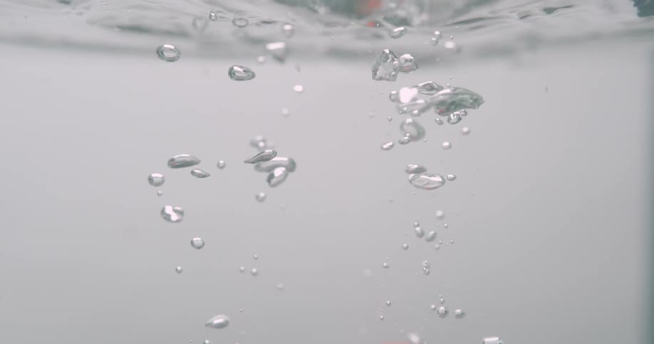 Bubbles in water rising towards the surface