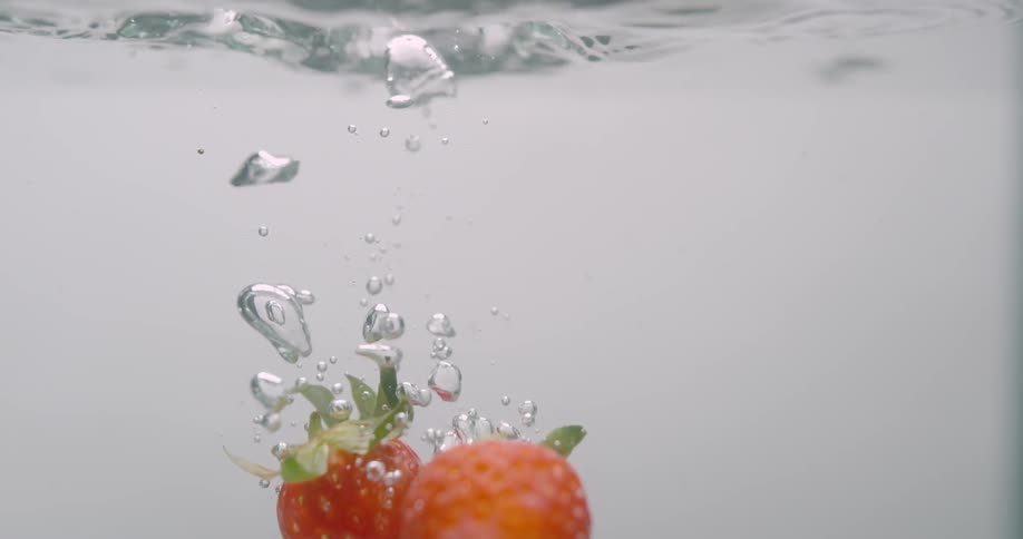 Strawberries falling in to water
