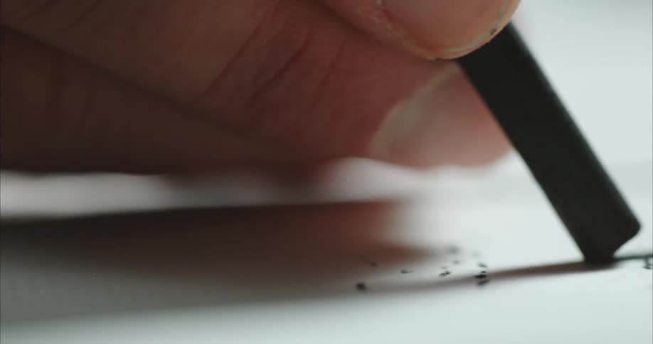 A hand draws a line