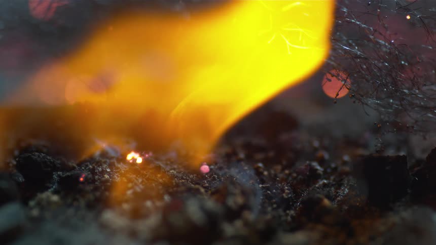 Flames burn on hot embers