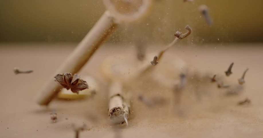 Dried lemon slices star anise and other herbs explode up then fall back to the surface