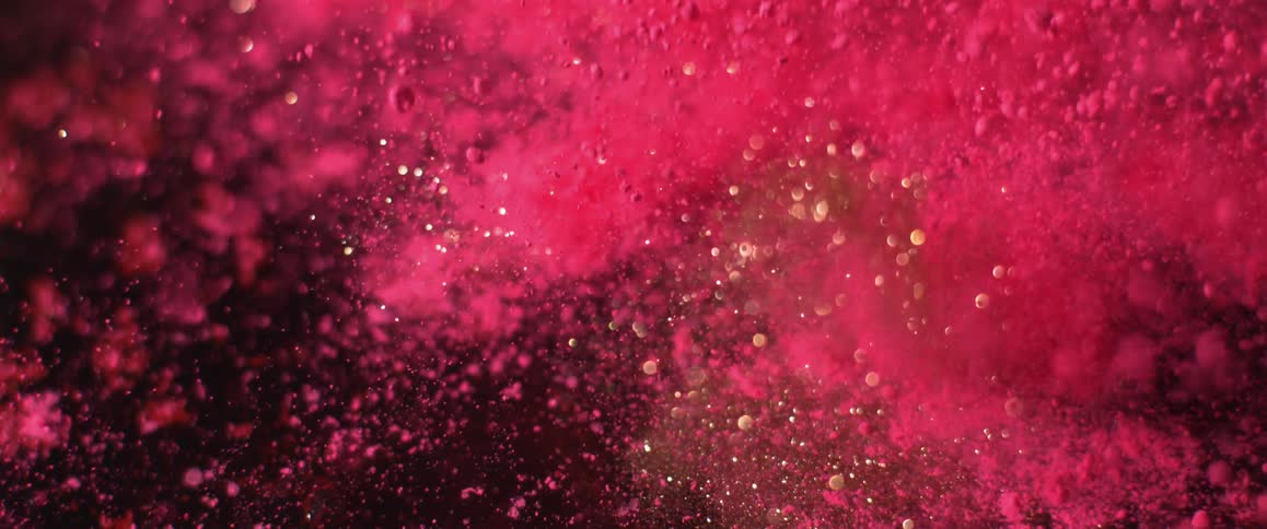 Glitter and pink dust shooting up in dust and scattered particles