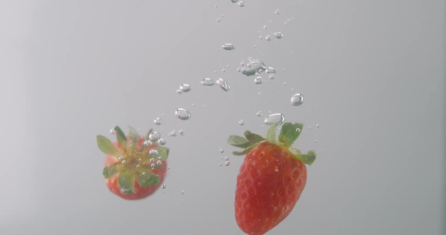 Strawberries in water with bubbles