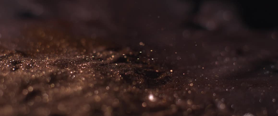 Shiny grains falling onto the ground