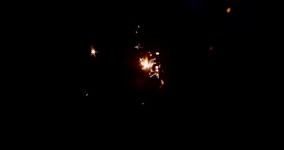 Sparkler throwing sparks in a dark room