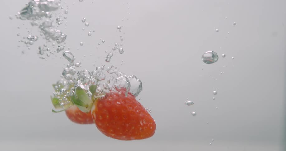 Strawberries falling in to water
