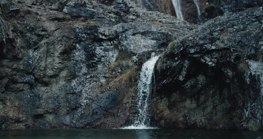 A waterfall crashes over the rocks