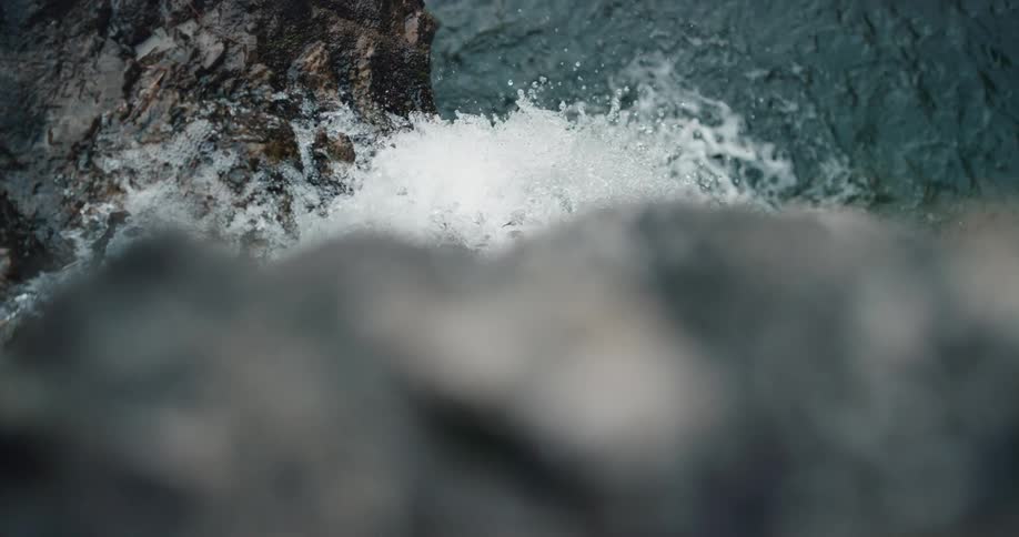 Slow motion waterfall flowing into river