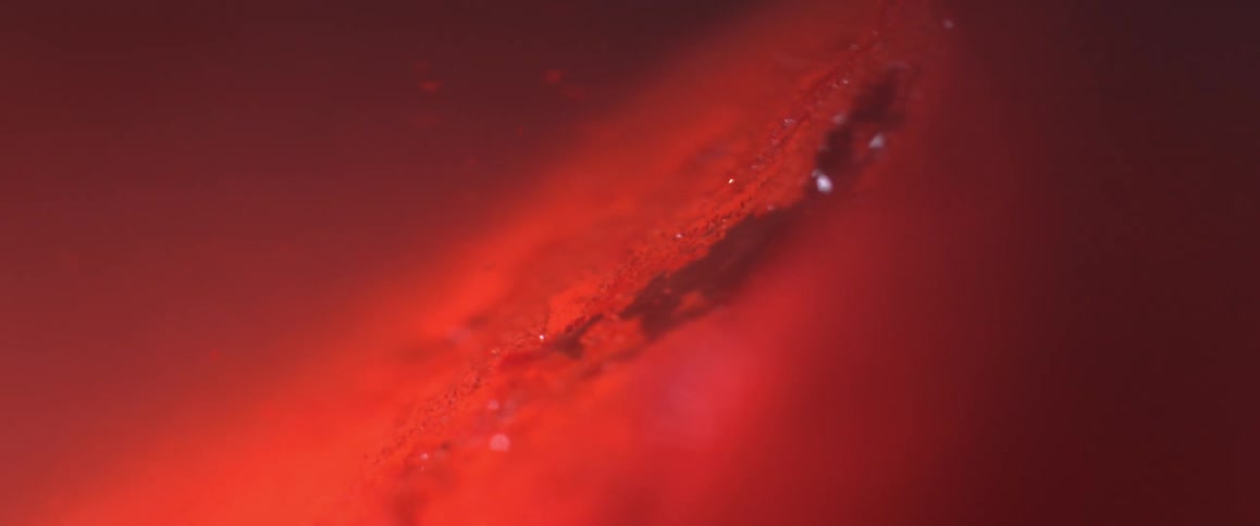 Glitter and dust under red light blown by wind