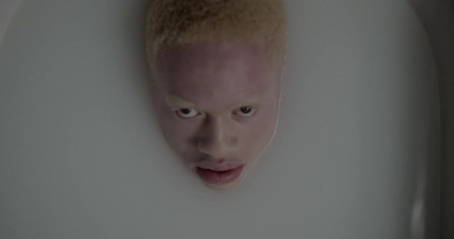 Birds eye view of a person in a tub with only their head emerged