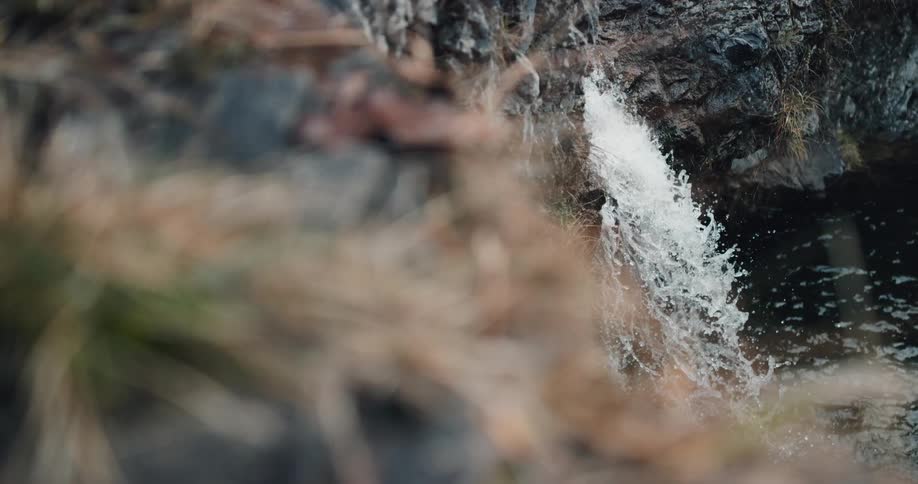 Waterfall flowing into a small river