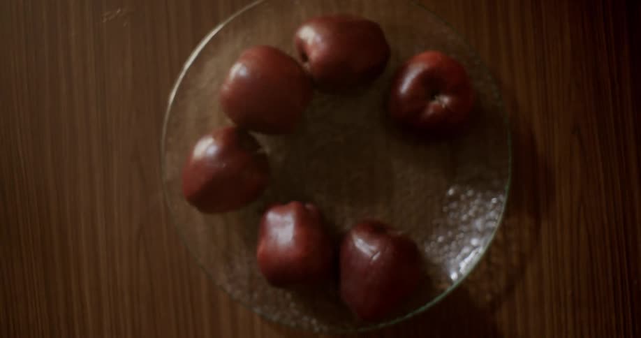 Apples in a bowl on a table jump up and fall out when the table is jostled