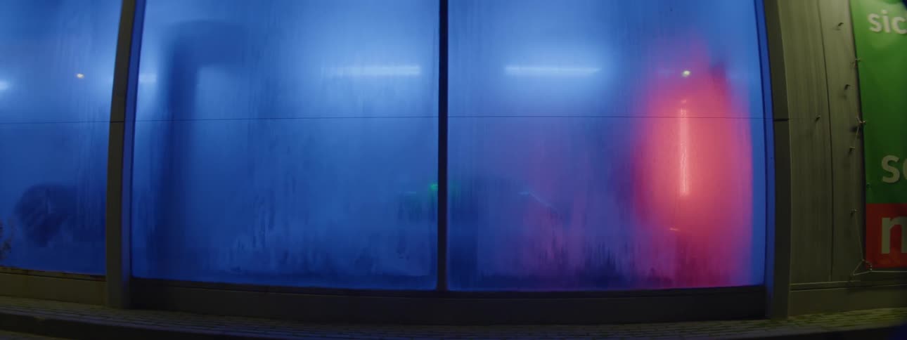 A window in a car wash with lights blinking