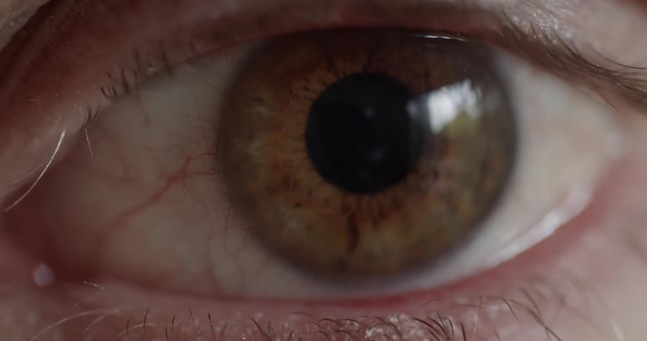 Ambereyed person opens their eye