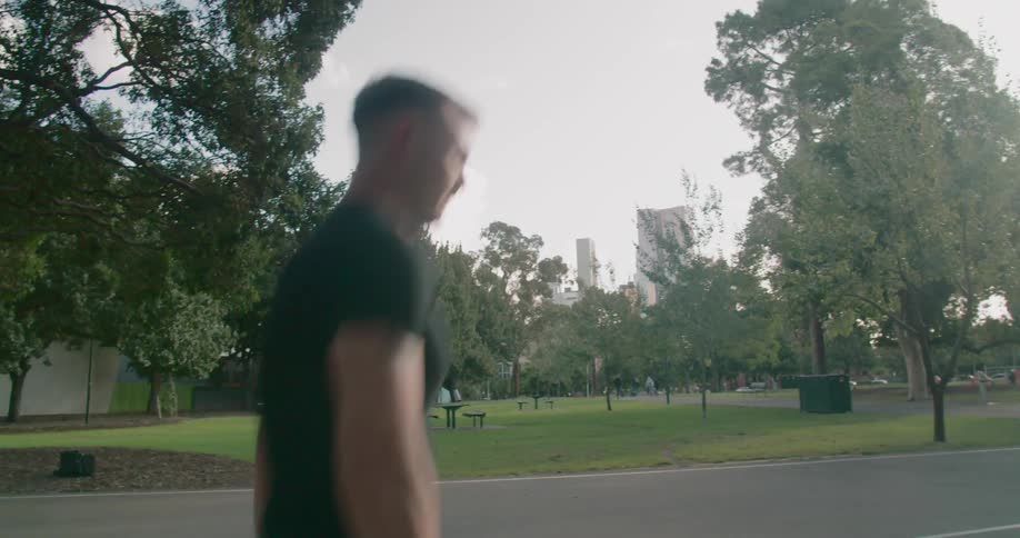 A young man dribbles a basketball outside