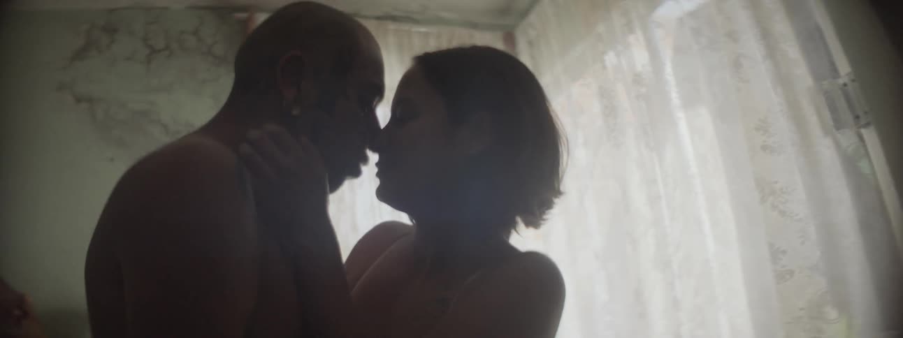 Couple kissing and making out in the middle of the living room