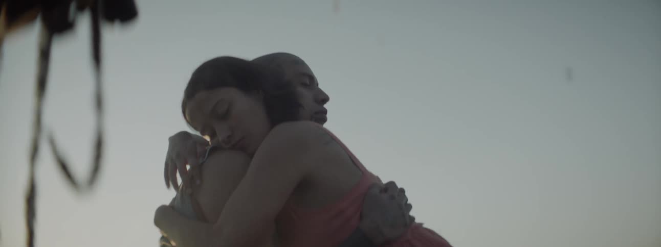 A man and woman embracing outdoors during the day