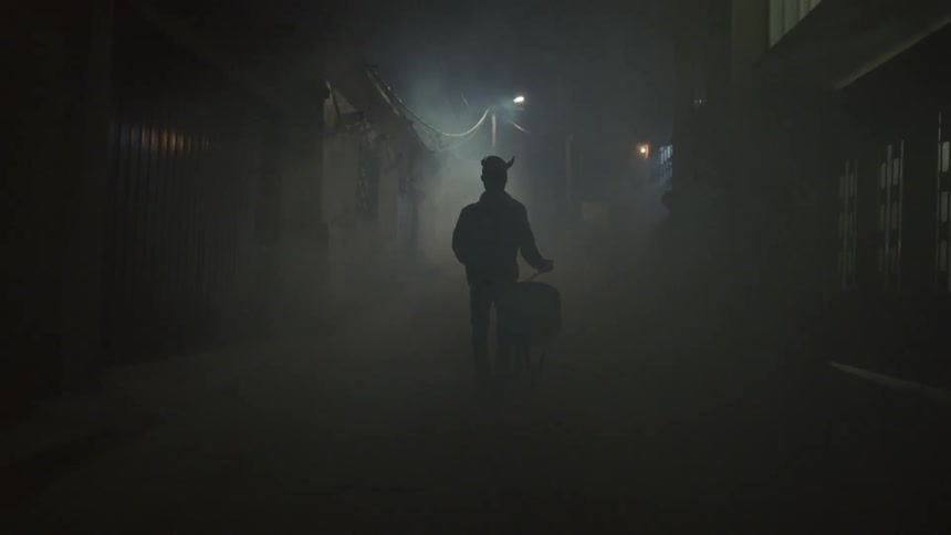A man drums in the darkness