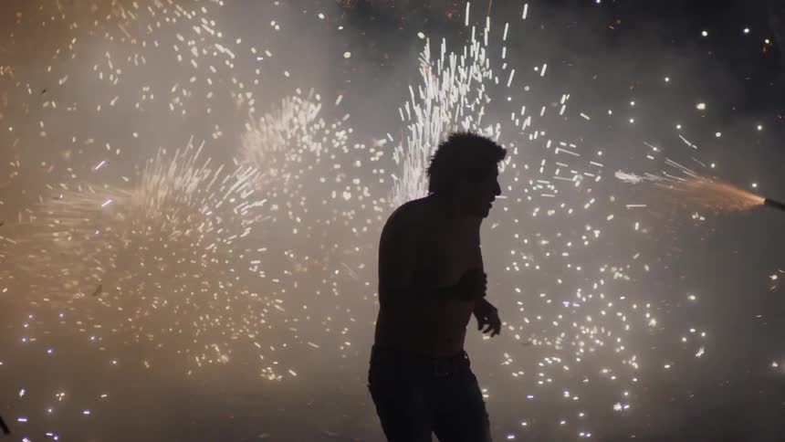Man runs at a fireworks display