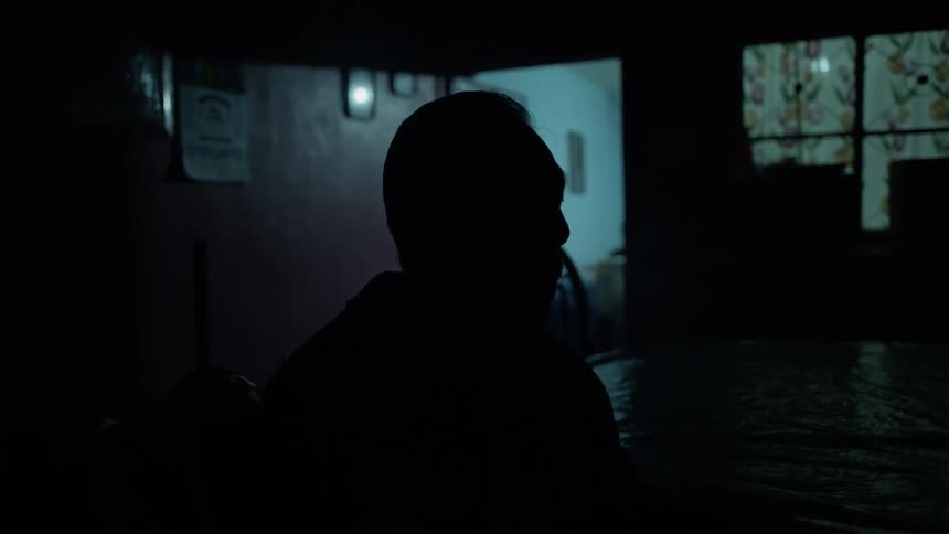 A man sitting at a table with lights flashing