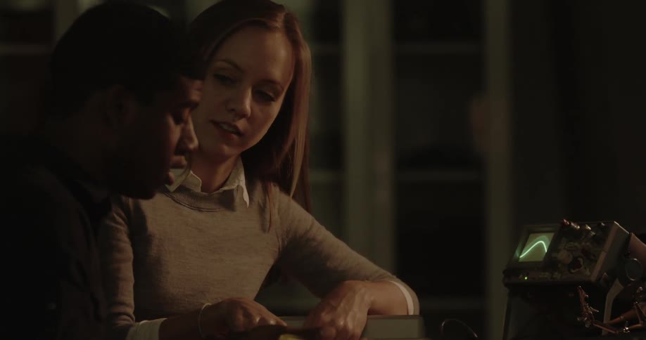 A woman talks to a man