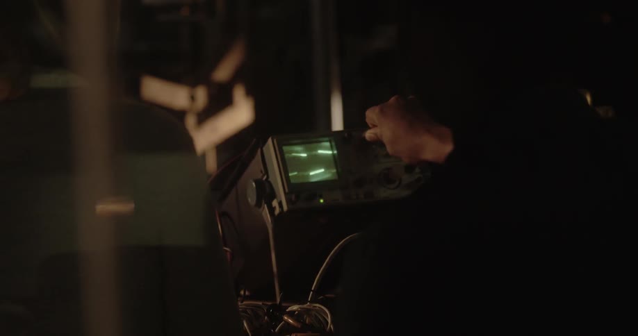 A young man turns a dial on a monitor