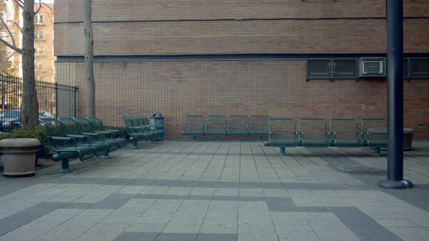 Benches sit empty next to a building