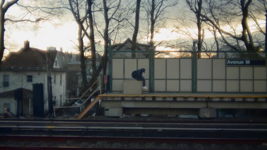 A man sits waiting for the train