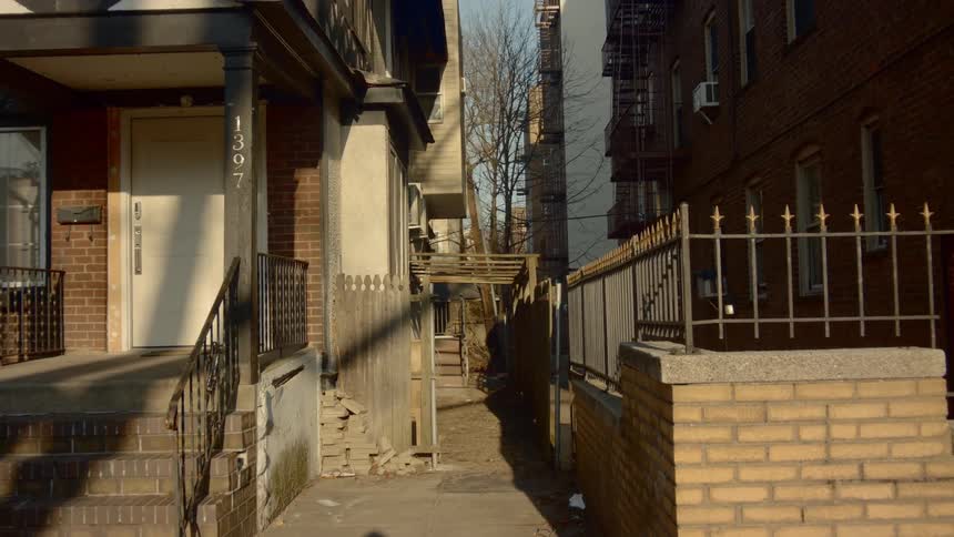 The alley is empty in the neighborhood