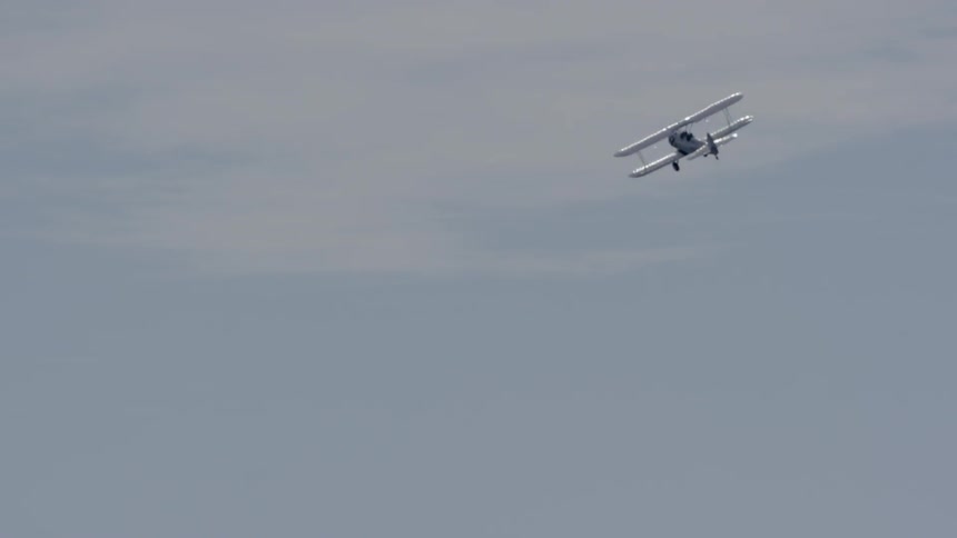 A small airplane flies in the sky