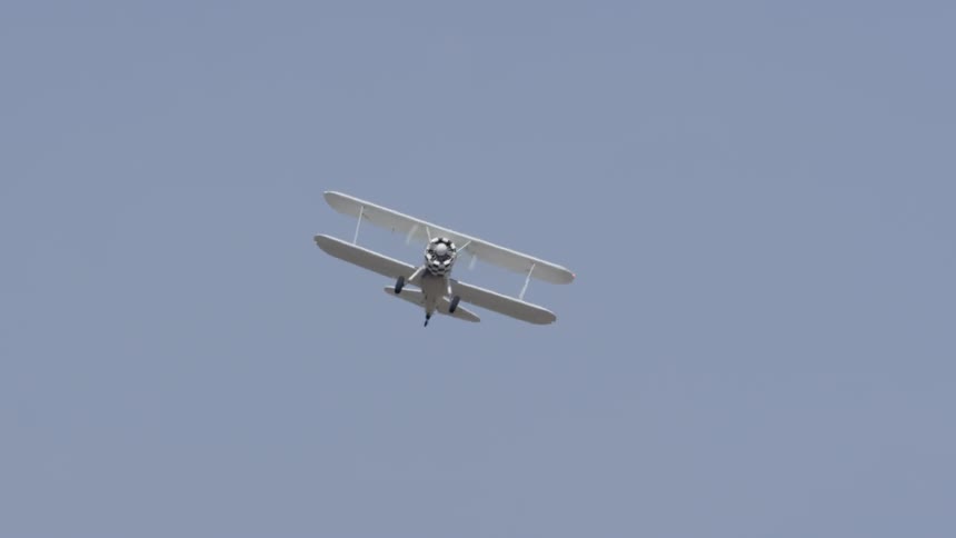 A small airplane is flying through the sky
