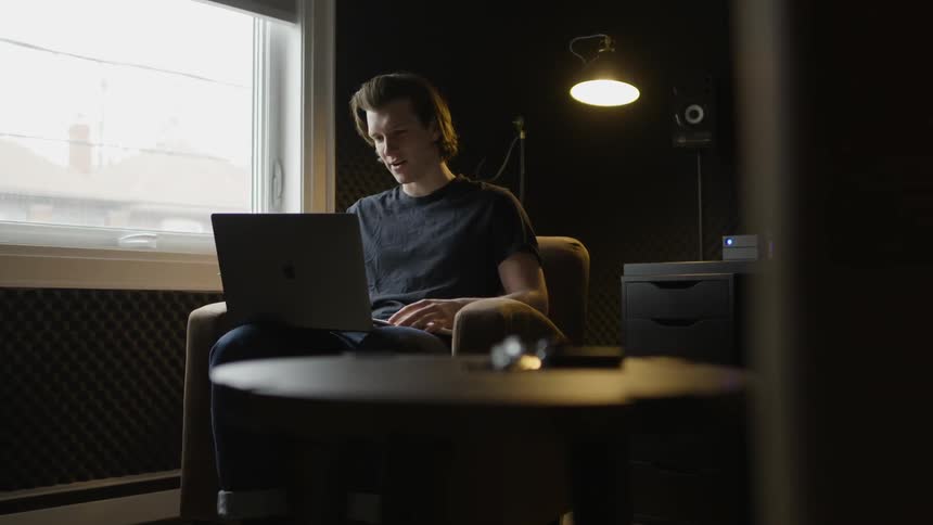 A man talks while looking at a computer