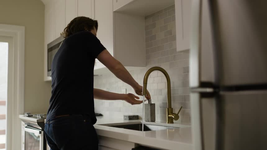 A man is washing his hands with soap