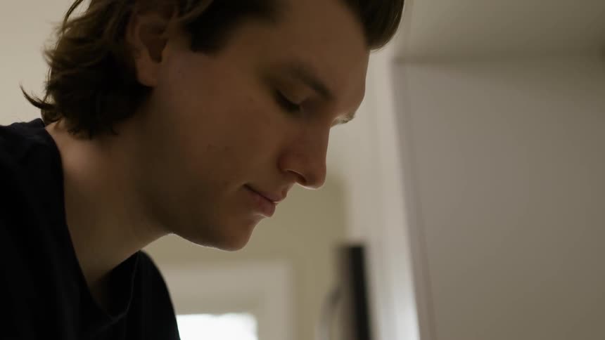 A young man looks down
