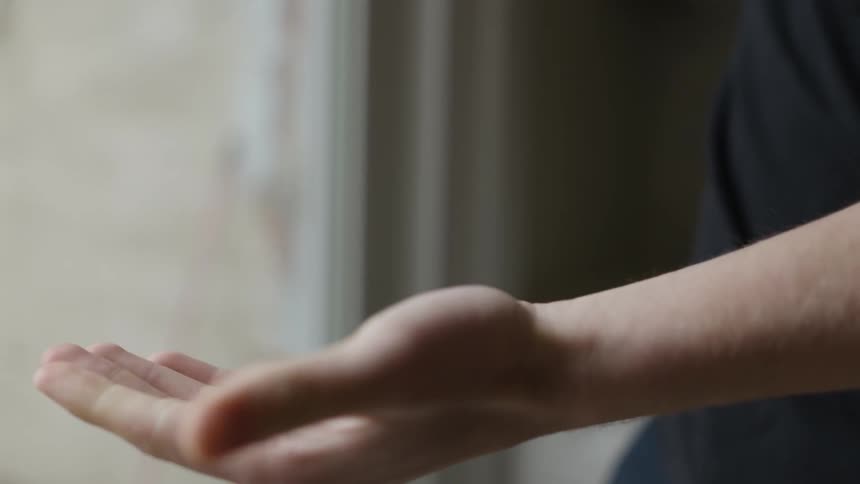 A man puts hand sanitizer in his hands and then rubs them together