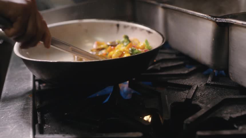 A pan heats vegetables